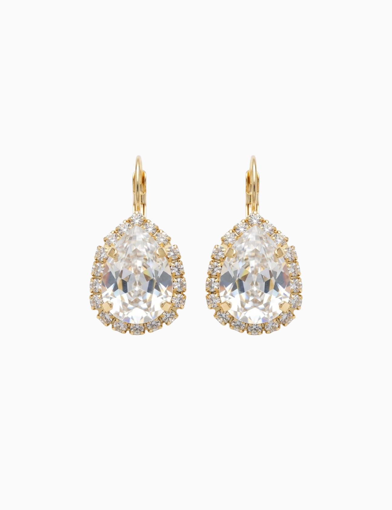 Pair of gold earrings with large clear gemstones on a white background