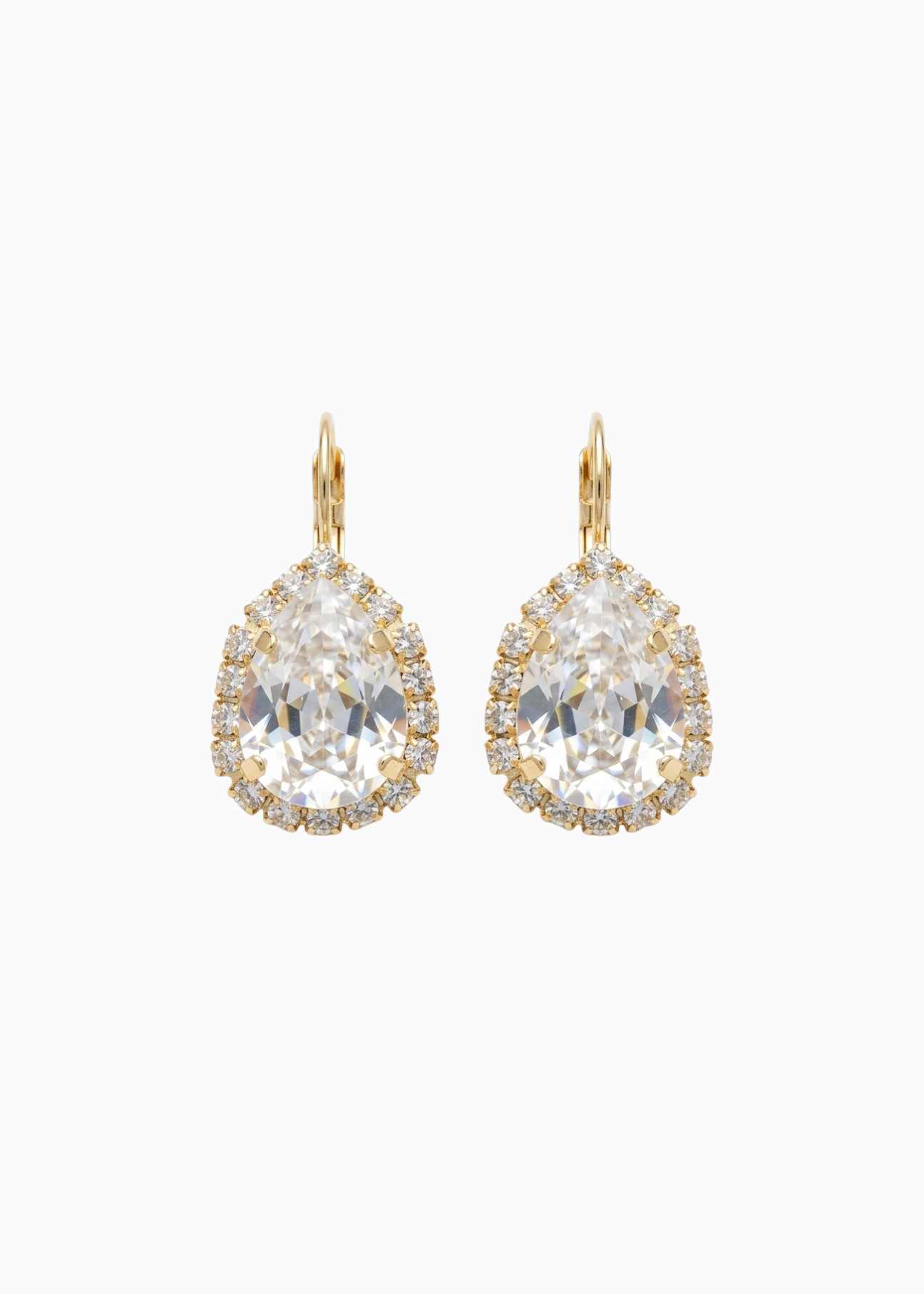 Pair of gold earrings with large clear gemstones on a white background