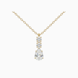 Gold necklace with a teardrop-shaped diamond pendant on a white background