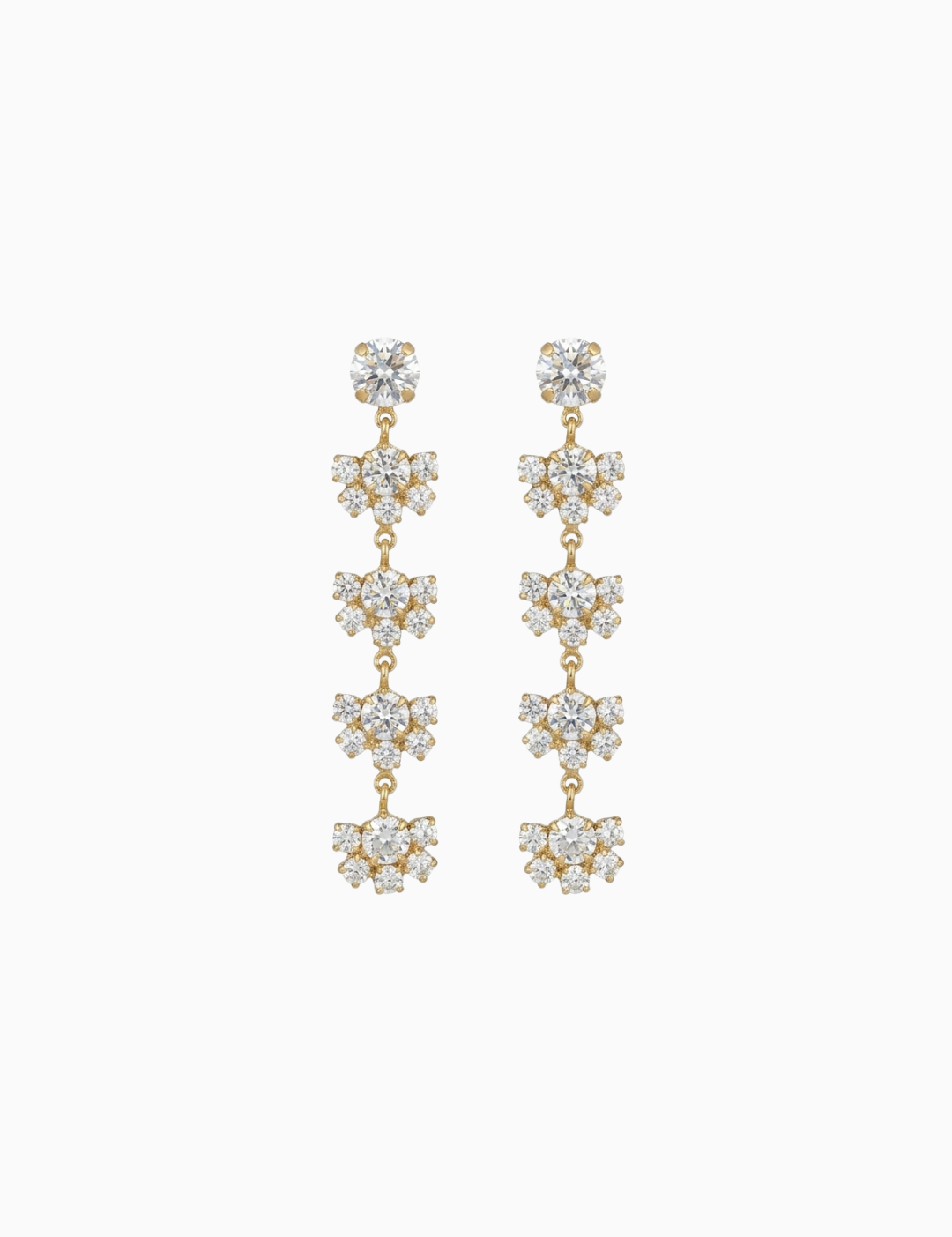 Pair of gold and crystal drop earrings on a white background