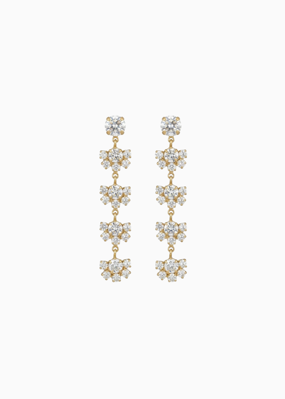 Pair of gold and crystal drop earrings on a white background