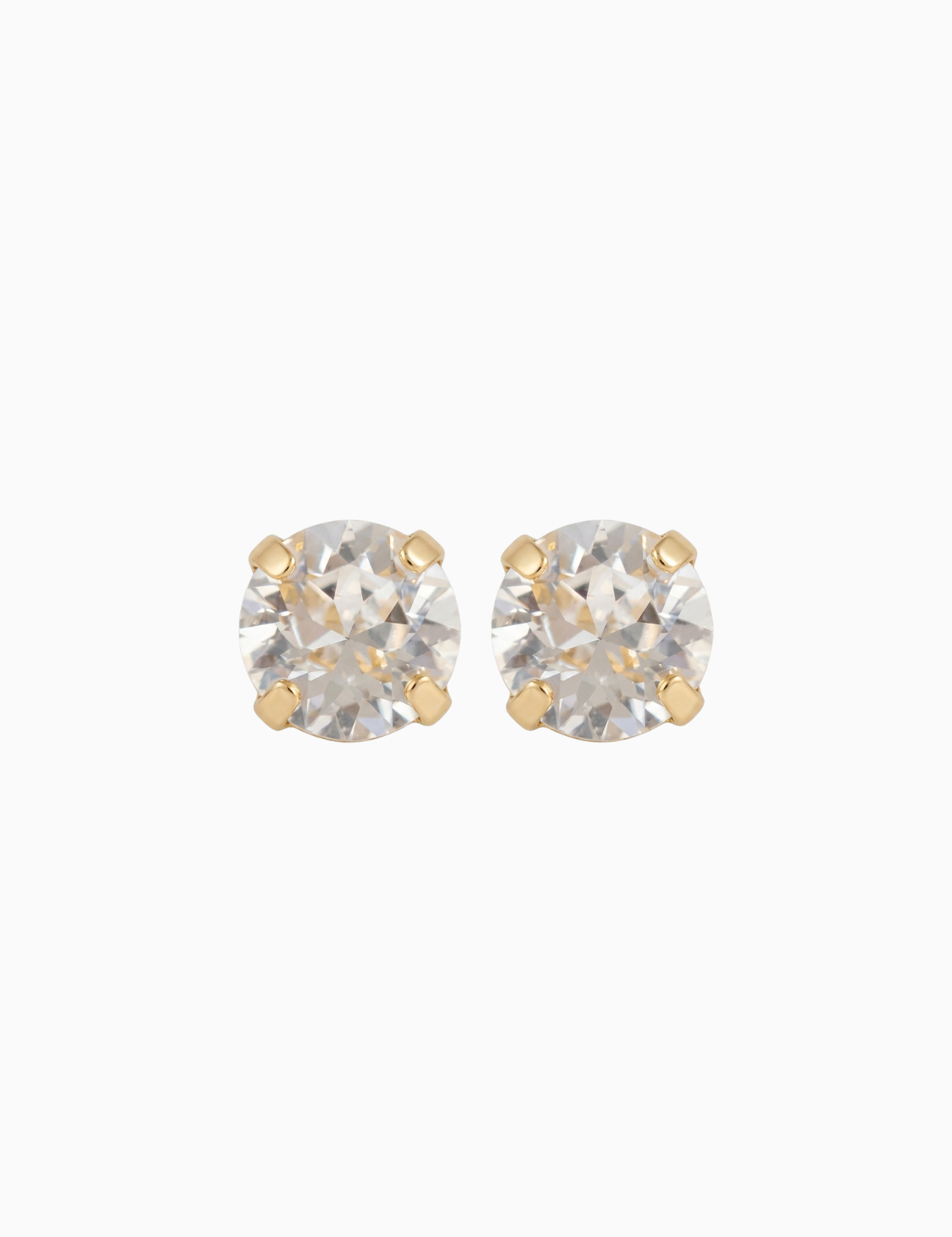 Pair of gold stud earrings with clear gemstones on a white background