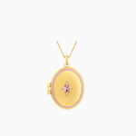An oval-shaped gold-plated  photo locket  featuring a pink cubic zirconia crystal, attached to a gold-plated chain.