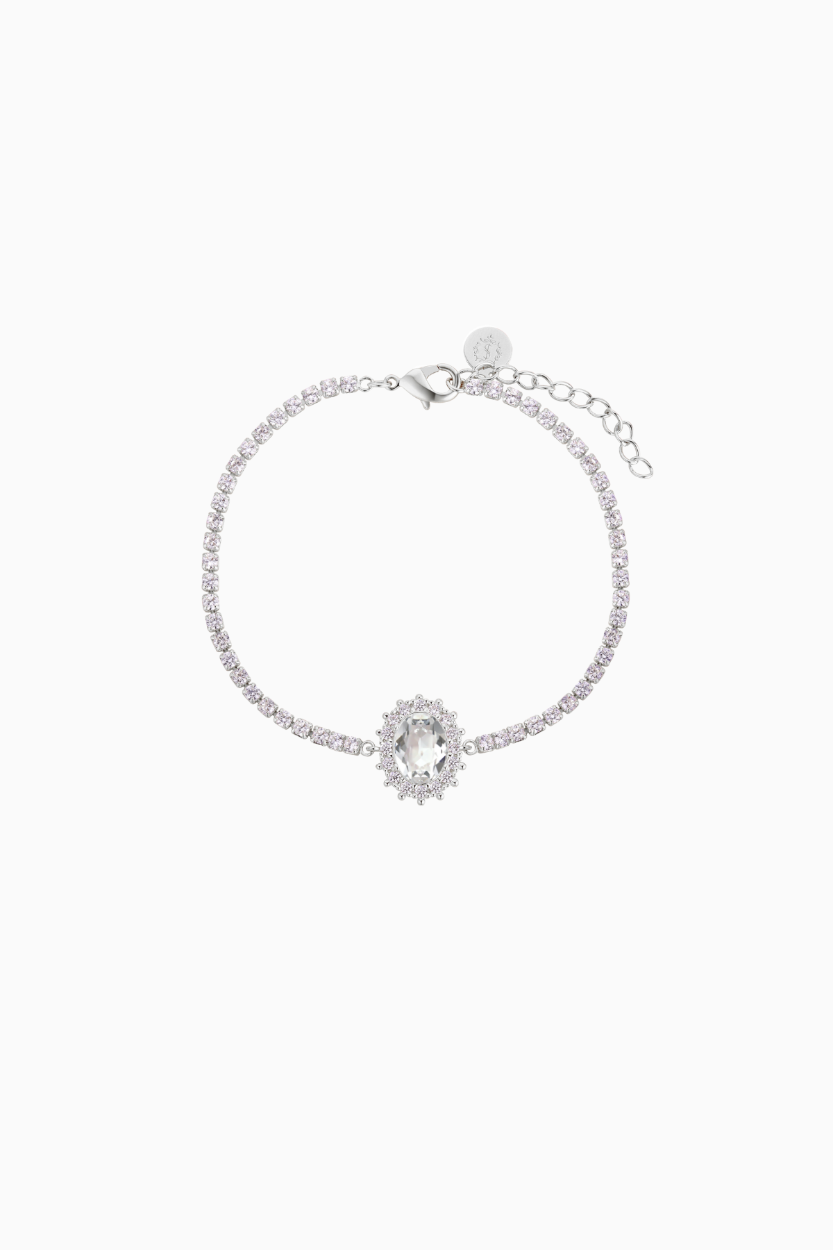 A rhodium-plated brass bracelet with a chain extension, featuring shimmering crystals arranged in an oval halo design by Sarah Gauci