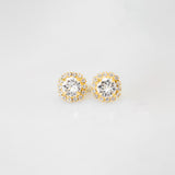 A pair of gold-colored stud earrings adorned with crystals, displayed against a white background.