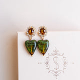 Heart-shaped earrings with green and brown stones by Sarah Gauci