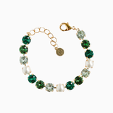 Bracelet with green and clear gemstones on a white background