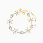 A gold-plated bracelet with crystal daisies and an extender chain.