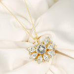 Gold necklace with a diamond pendant on a soft beige fabric background