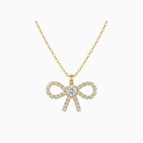 Gold bow-shaped necklace with diamonds on a white background