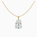 Gold necklace with a clear gemstone pendant on a white background