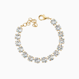 Gold bracelet with clear gemstones on a white background