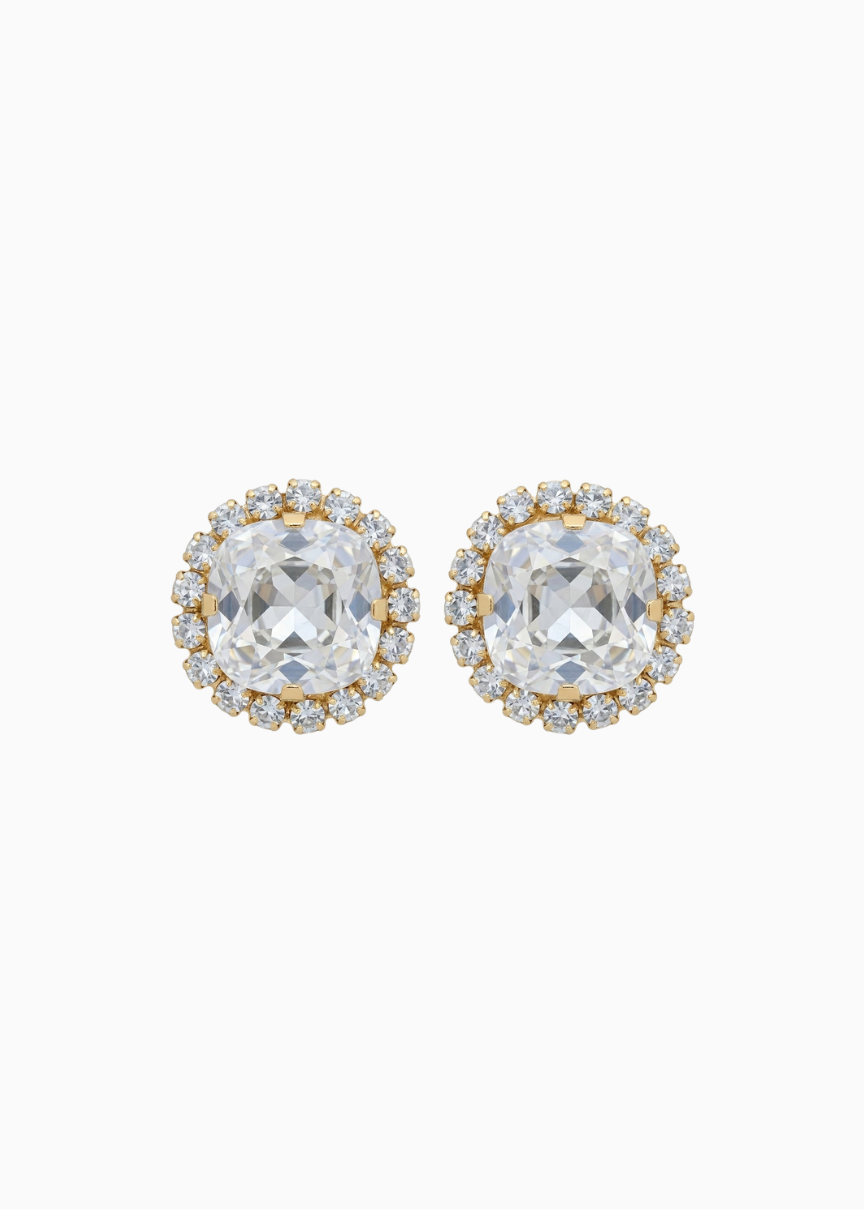 Pair of gold and clear crystal stud earrings on a white background