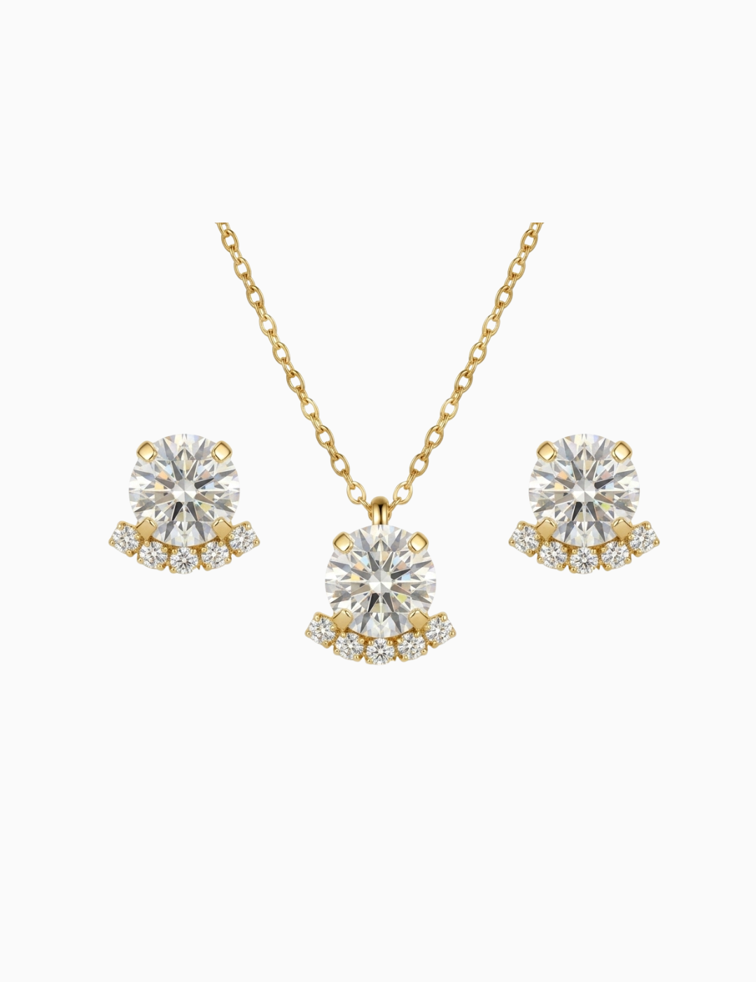 Gold necklace and earrings with clear gemstones on a white background