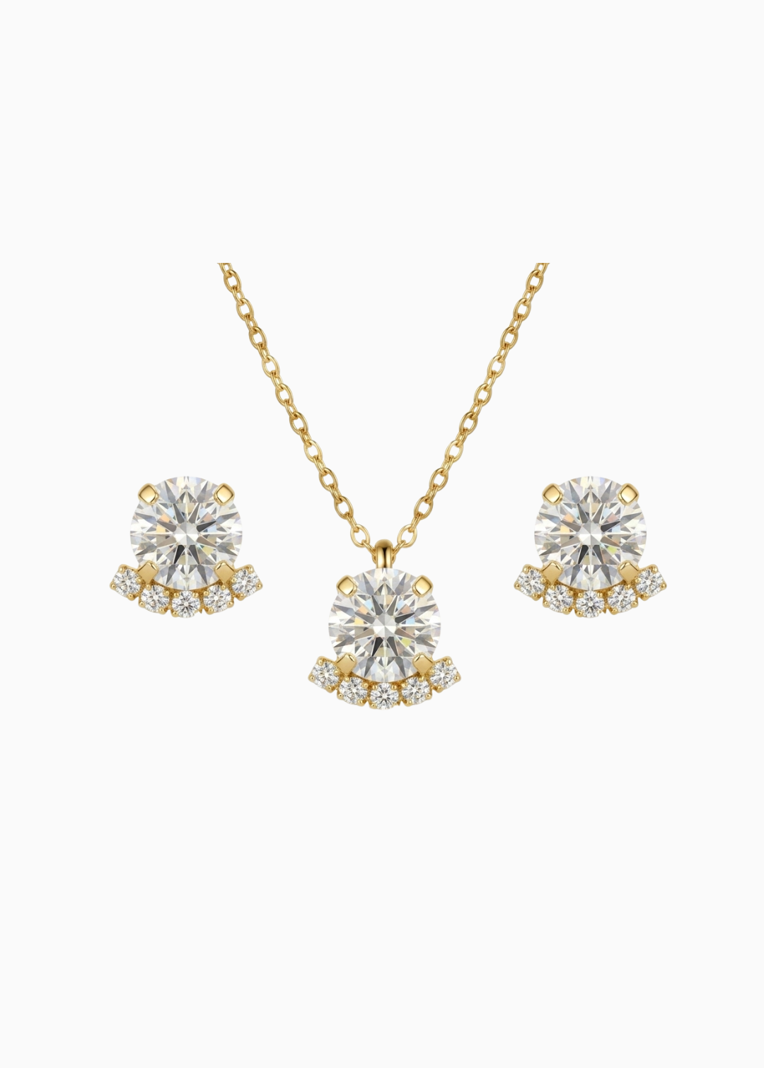Gold necklace and earrings with clear gemstones on a white background