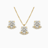 Gold necklace and earrings with clear gemstones on a white background