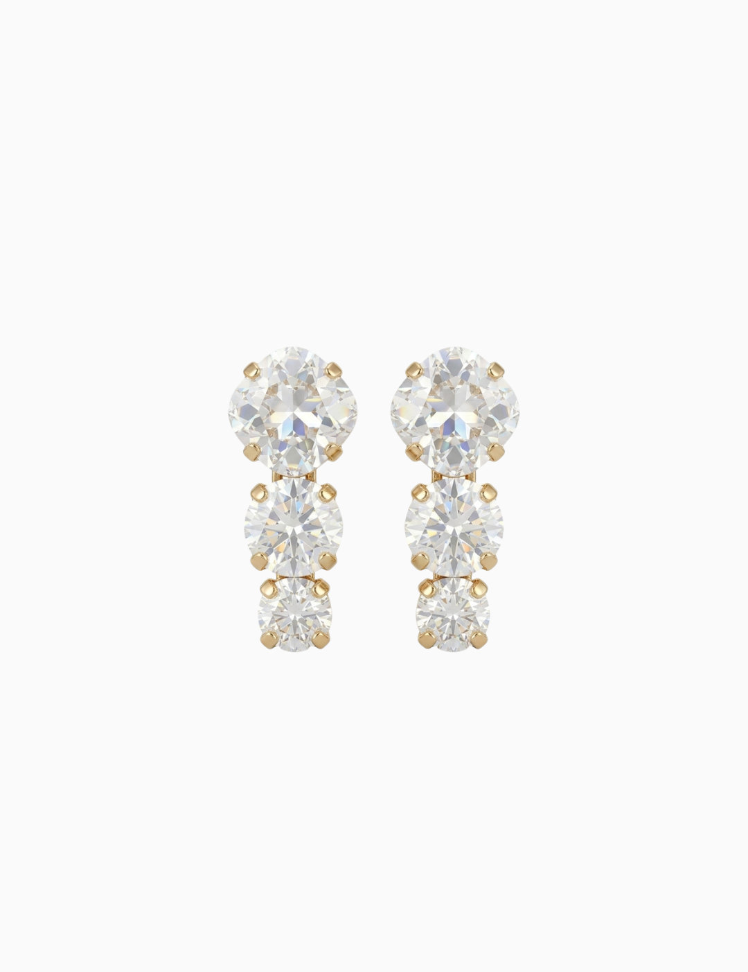 Pair of gold and clear crystal earrings on a white background