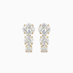 Pair of gold and clear crystal earrings on a white background