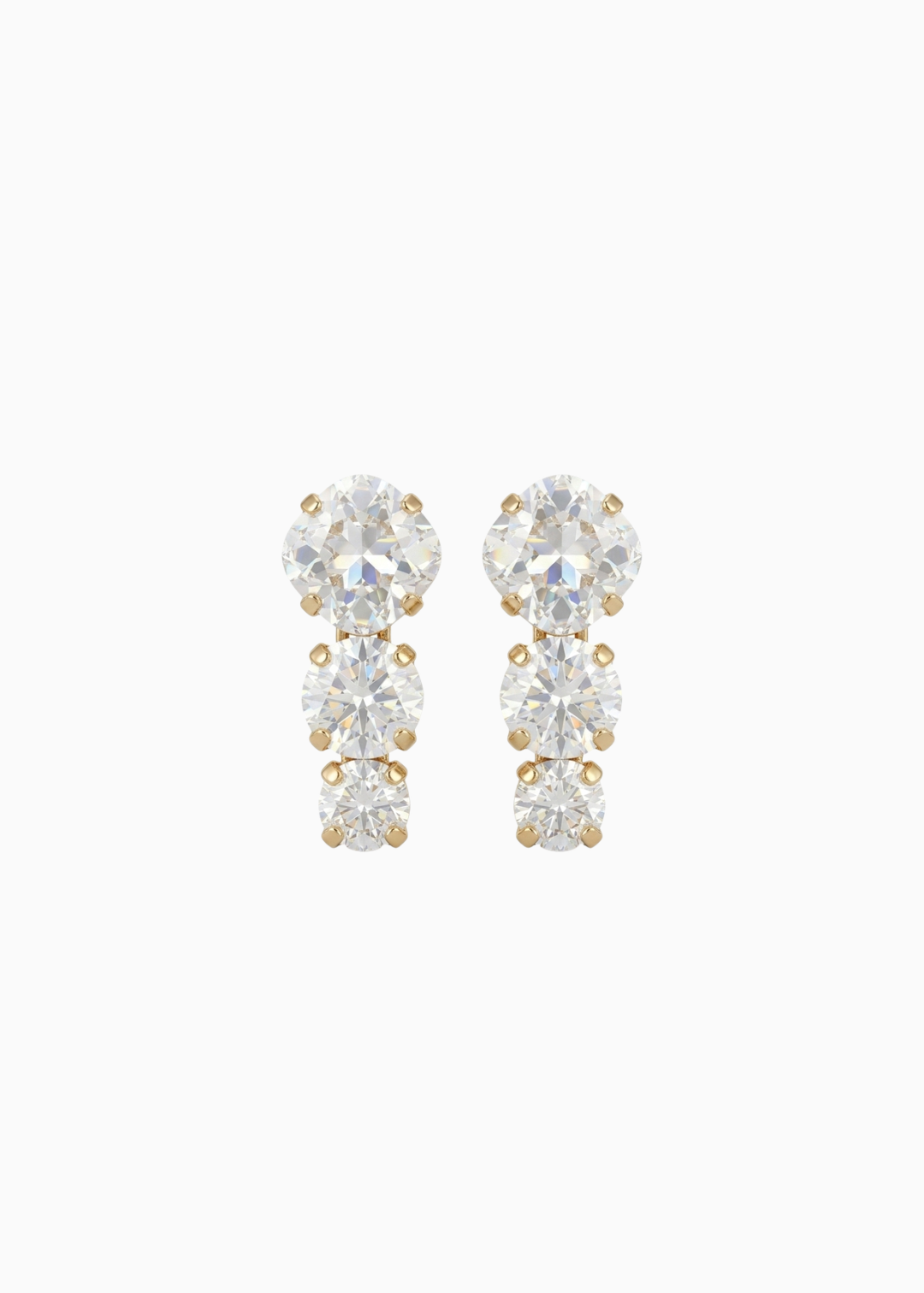 Pair of gold and clear crystal earrings on a white background