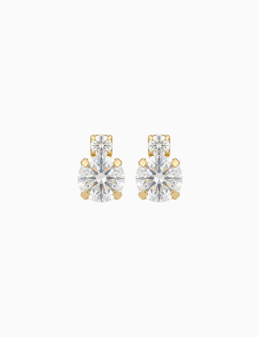 Pair of gold and clear stud earrings on a white background
