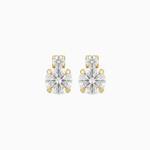 Pair of gold and clear stud earrings on a white background