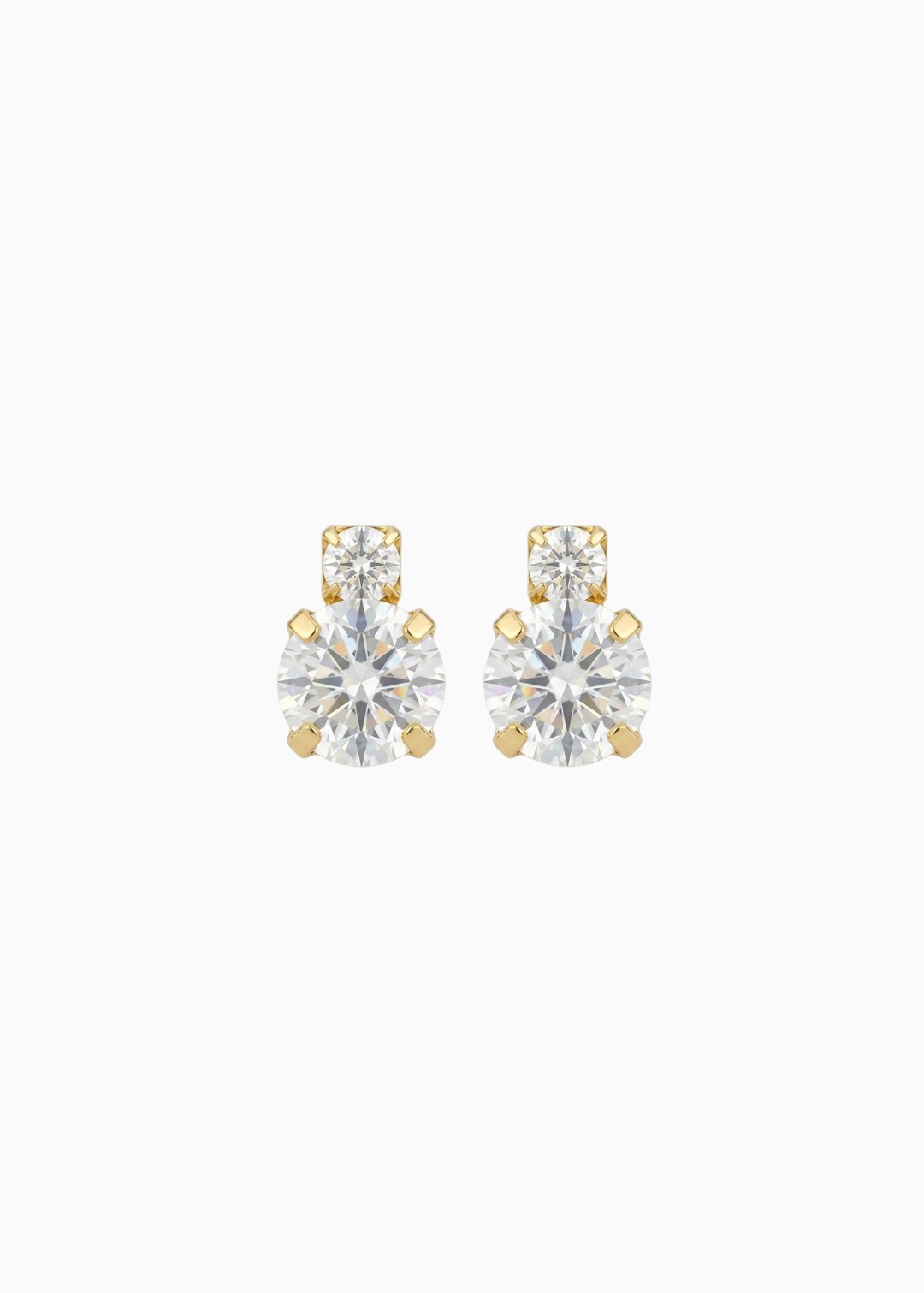Pair of gold and clear stud earrings on a white background