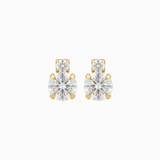 Pair of gold and clear stud earrings on a white background