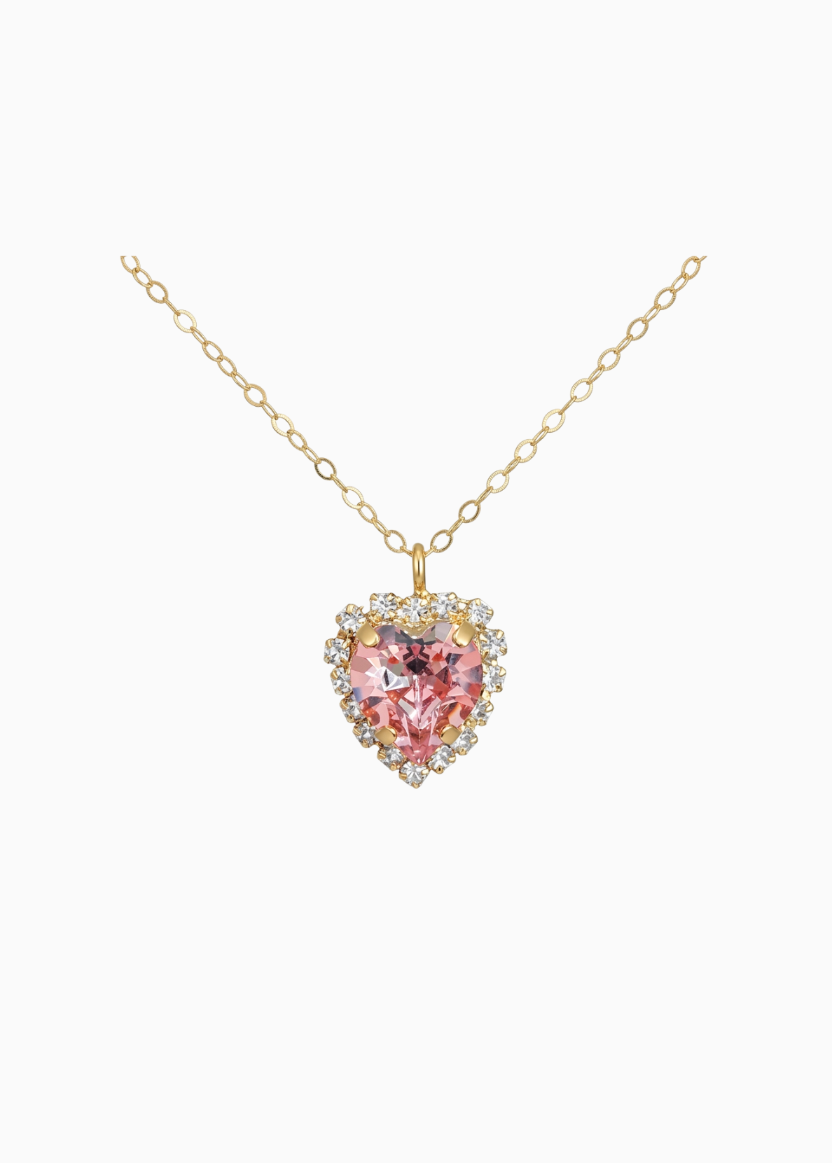 Gold necklace with a heart-shaped pink gemstone pendant on a white background