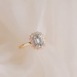 Gold ring with a diamond on a beige background