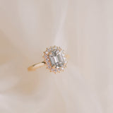 Gold ring with a diamond on a beige background