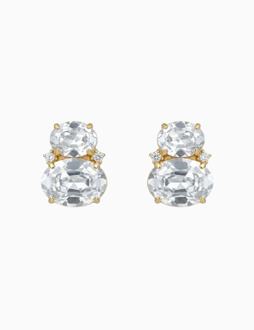 Pair of gold and clear crystal stud earrings on a white background
