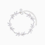 A rhodium-plated bracelet adorned with high-quality shimmering crystals and pearls, featuring a floral pattern and a chain extender.