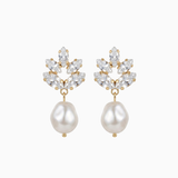 Pair of earrings with pearl drops and crystal accents on a white background