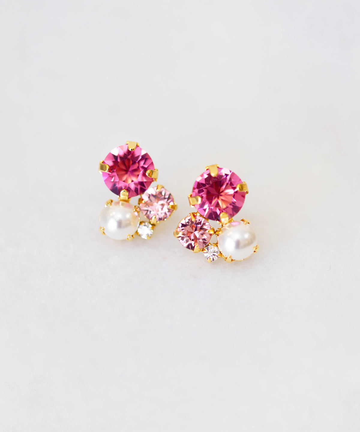 A pair of pink crystal and pearl stud earrings, with gold plating by Sarah Gauci Malta