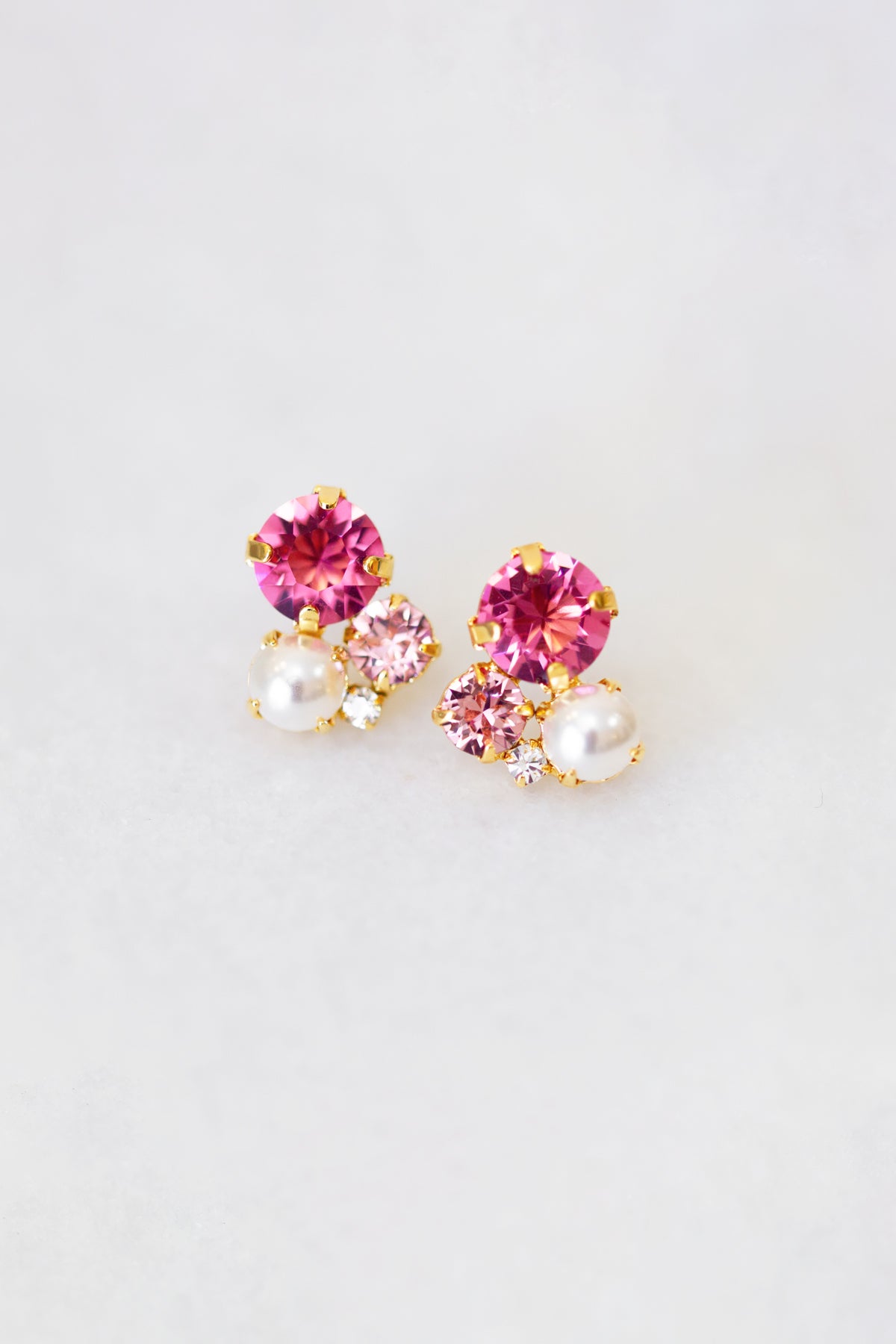 A pair of pink crystal and pearl stud earrings, with gold plating by Sarah Gauci Malta