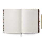 Open notebook with lined pages and a pen on a white background