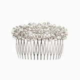Silver hair comb with pearls and crystals on a white background