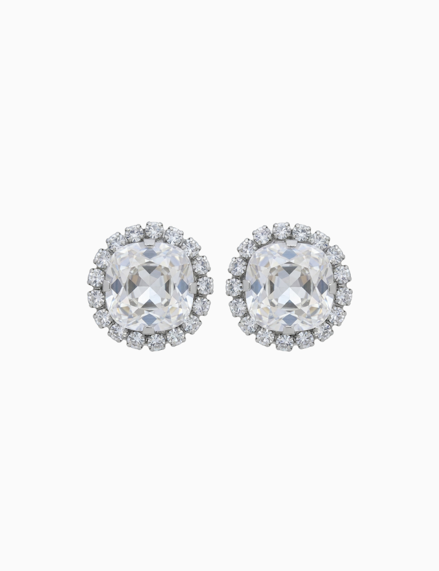 Pair of silver earrings with clear gemstones on a white background