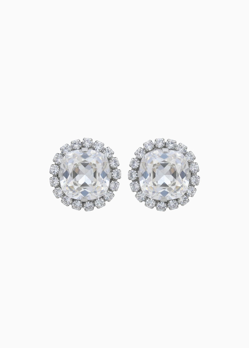 Pair of silver earrings with clear gemstones on a white background