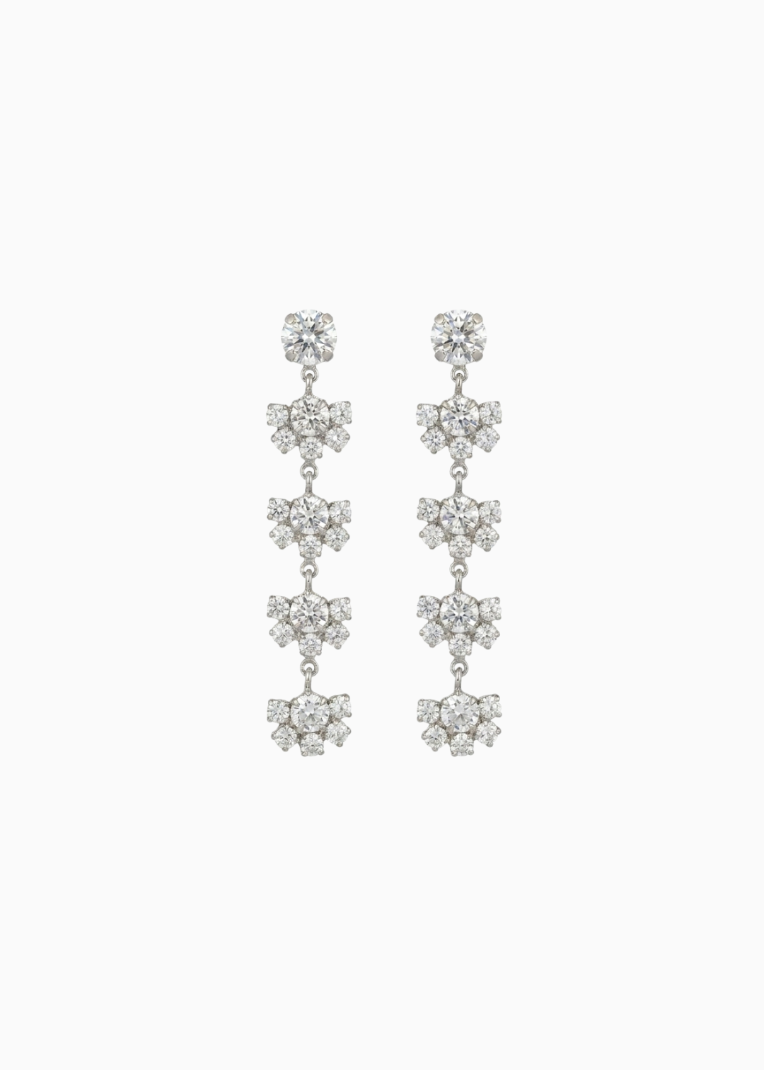 Pair of silver floral earrings on a white background