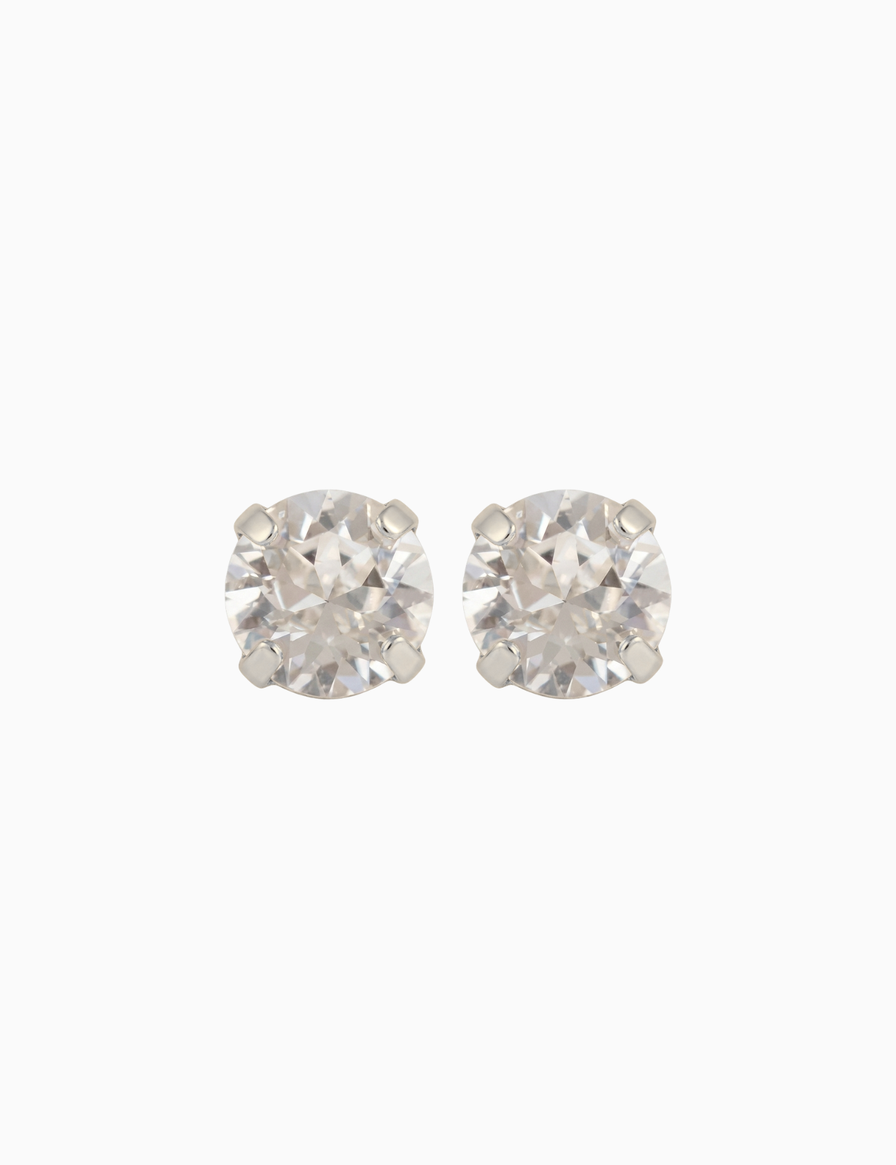 Pair of silver stud earrings on a white background