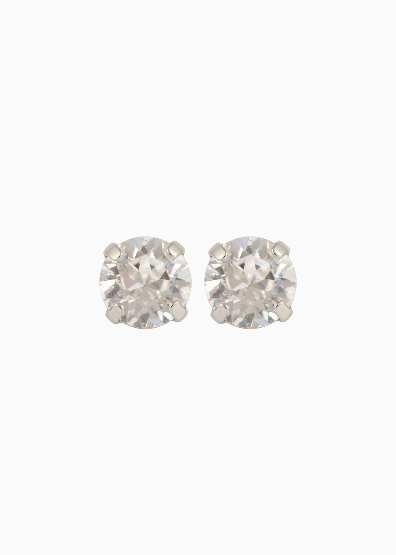 Pair of silver stud earrings on a white background