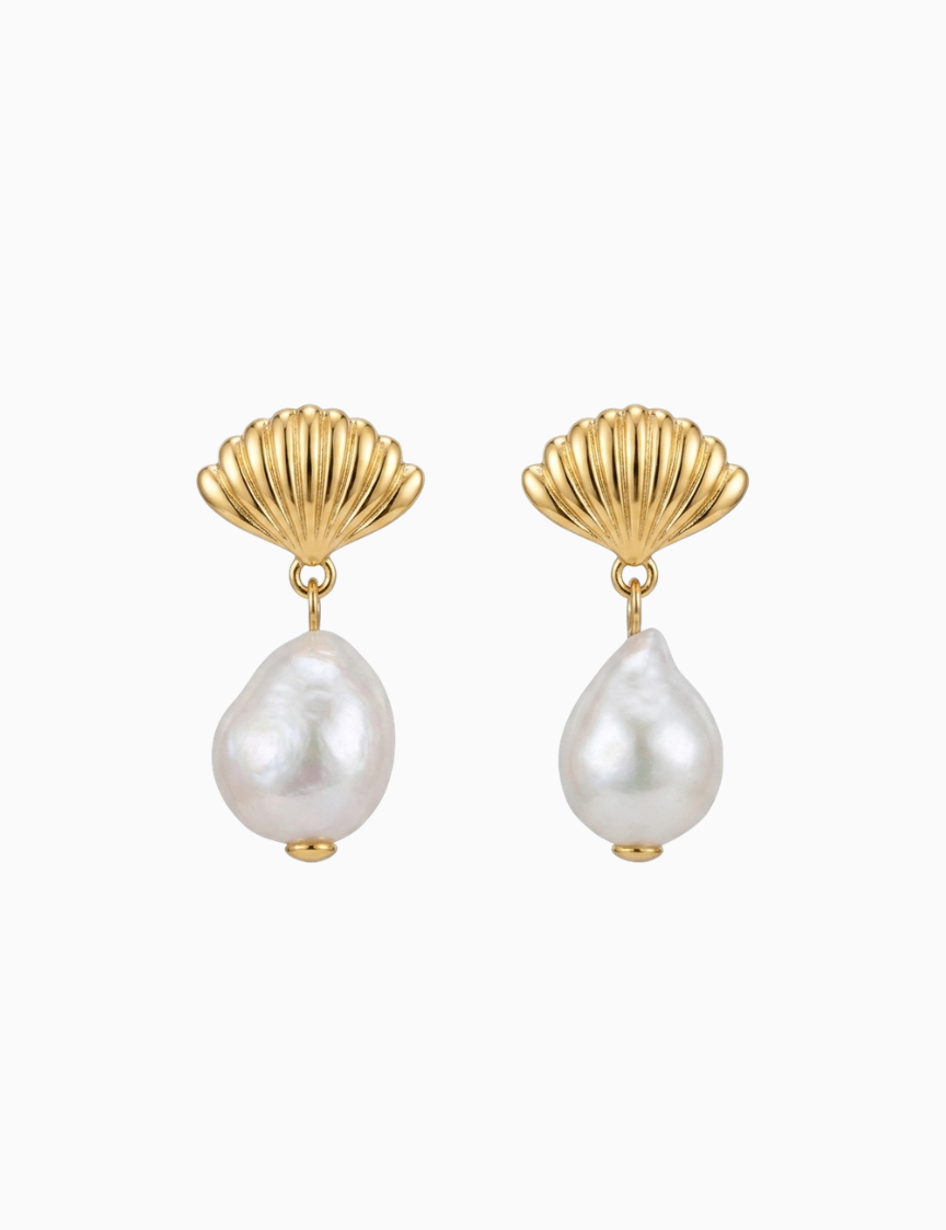 Pair of earrings with gold shell designs and pearl drops on a white background