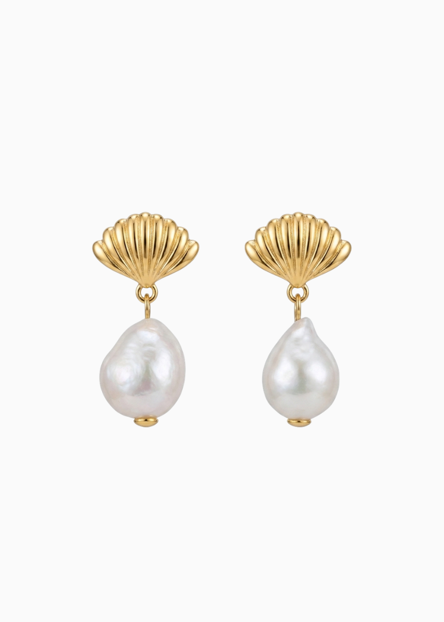 Pair of earrings with gold shell designs and pearl drops on a white background