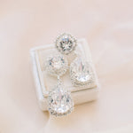 A pair of elegant teardrop crystal earrings with intricate halo detailing, perfect for a bride's wedding day look by Sarah Gauci Malta