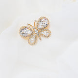 Petunia crystal butterfly brooch by Sarah Gauci, featuring hand-set crystals in an 18K gold-plated setting.