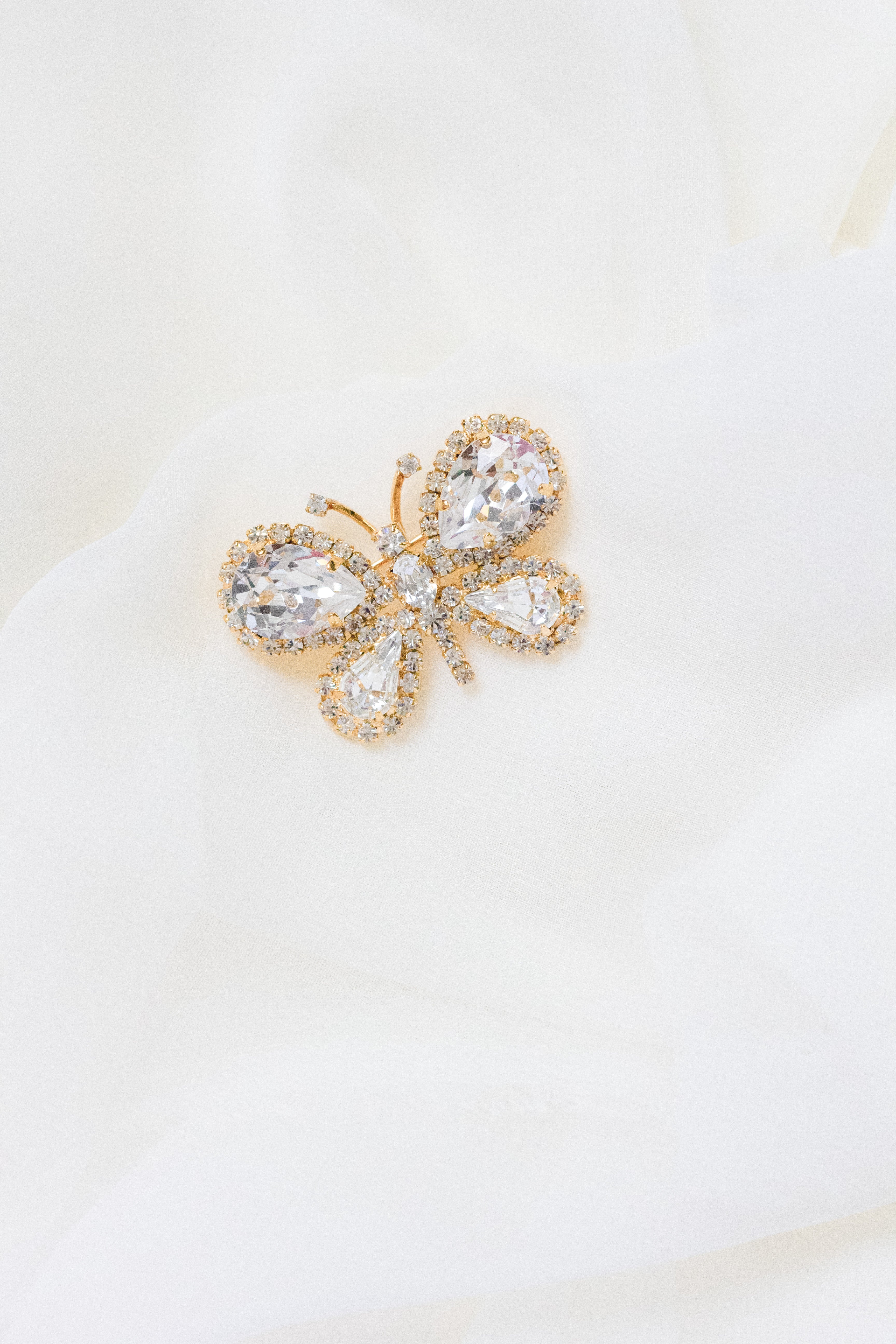 Petunia crystal butterfly brooch by Sarah Gauci, featuring hand-set crystals in an 18K gold-plated setting.